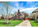 Beautiful Tudor-style house featuring brickwork, a chimney, and a well-kept front lawn at 5611 N Delaware St, Indianapolis, IN 46220
