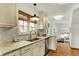Bright kitchen features granite countertops, stainless steel appliances and is filled with natural light at 5611 N Delaware St, Indianapolis, IN 46220