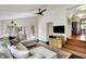 Bright living room with a ceiling fan, stylish rug, and a view of the open floor plan of the home at 5611 N Delaware St, Indianapolis, IN 46220