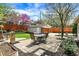 Outdoor patio with dining set, surrounded by lush greenery, trees and privacy fence at 5611 N Delaware St, Indianapolis, IN 46220