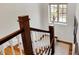 White staircase featuring stained handrails and stair treads and a large window providing natural light at 5611 N Delaware St, Indianapolis, IN 46220