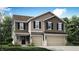 Charming townhome showcasing neutral siding, black shutters, and a convenient attached two-car garage at 5725 Sunstone Rd, Indianapolis, IN 46239