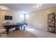 Spacious finished basement with a pool table, television, and shelving unit at 5895 Sugar Pine Dr, Avon, IN 46123