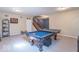 Finished basement with a pool table, staircase, and display shelving at 5895 Sugar Pine Dr, Avon, IN 46123