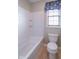 Bright bathroom with a white bathtub and shower combination at 5895 Sugar Pine Dr, Avon, IN 46123