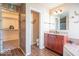 Well-lit bathroom with double vanity, tiled floors, and walk-in closet at 5895 Sugar Pine Dr, Avon, IN 46123