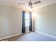 Simple bedroom featuring neutral tones, a window, and a ceiling fan at 5895 Sugar Pine Dr, Avon, IN 46123