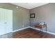 A comfortable bedroom has hardwood floors with a vintage typewriter on a small table and double closets at 5895 Sugar Pine Dr, Avon, IN 46123