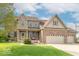Charming two-story brick home with a three-car garage and well-maintained lawn at 5895 Sugar Pine Dr, Avon, IN 46123