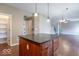 Kitchen island with dark countertops and ample storage space at 5895 Sugar Pine Dr, Avon, IN 46123