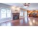 Open-concept living room with a fireplace, hardwood floors, and natural light at 5895 Sugar Pine Dr, Avon, IN 46123