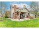 Covered patio with stone fireplace and outdoor seating area in a spacious backyard at 5895 Sugar Pine Dr, Avon, IN 46123