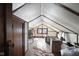A view of the attic with unfinished walls, wooden floors and a small window at 617 Carlyle Pl, Indianapolis, IN 46201