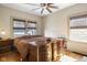 Bedroom with wood floors, two windows with blinds, wooden dressers and ceiling fan at 617 Carlyle Pl, Indianapolis, IN 46201