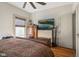 Cozy bedroom with hardwood floors, television, wooden dressers and ceiling fan at 617 Carlyle Pl, Indianapolis, IN 46201