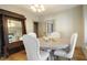 Bright dining room with hardwood floors, neutral paint, and modern light fixture at 617 Carlyle Pl, Indianapolis, IN 46201