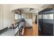 Charming kitchen features stainless steel appliances, wooden floors and a view to the dining area at 617 Carlyle Pl, Indianapolis, IN 46201