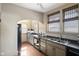 Sun-lit kitchen with wooden floors, double basin sink and earth tone cabinetry at 617 Carlyle Pl, Indianapolis, IN 46201