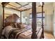 Primary bedroom suite with four poster bed, hardwood floors, and natural light at 617 Carlyle Pl, Indianapolis, IN 46201