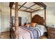 Primary bedroom suite featuring hardwood floors and decorative four poster bed at 617 Carlyle Pl, Indianapolis, IN 46201
