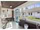 Inviting sunroom with bright windows, brick accents, and neutral flooring at 617 Carlyle Pl, Indianapolis, IN 46201