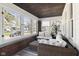 Inviting sunroom with wicker furniture and an abundance of natural light at 617 Carlyle Pl, Indianapolis, IN 46201