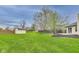 Backyard featuring a large grassy area, a shed, nice landscaping and a stained wood fence at 6218 Churchman Way, Indianapolis, IN 46237