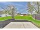 The backyard featuring a concrete patio, lawn and a storage shed at 6218 Churchman Way, Indianapolis, IN 46237