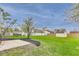 Backyard showcasing a lawn and patio with landscaping and a storage shed at 6218 Churchman Way, Indianapolis, IN 46237