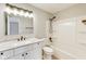 Well-lit bathroom features a shower-tub combo and granite countertops at 6218 Churchman Way, Indianapolis, IN 46237