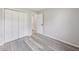 Spacious bedroom features a closet, light gray walls, and gray wood floors at 6218 Churchman Way, Indianapolis, IN 46237