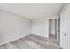 Bright bedroom features a closet, light gray walls, and gray wood floors at 6218 Churchman Way, Indianapolis, IN 46237
