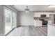 Dining area featuring modern light fixture, sliding glass doors and an adjacent kitchen area at 6218 Churchman Way, Indianapolis, IN 46237