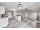 Open kitchen featuring stylish pendant lighting, gray countertops, and direct view into the Gathering room at 6218 Churchman Way, Indianapolis, IN 46237