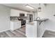 Modern kitchen with stainless appliances, white cabinetry, subway tile backsplash and bar top at 6218 Churchman Way, Indianapolis, IN 46237