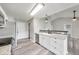 Bright kitchen features stainless steel appliances, granite countertops, and gray wood floors at 6218 Churchman Way, Indianapolis, IN 46237