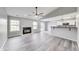 Open-concept living room featuring fireplace, neutral gray walls, and modern flooring at 6218 Churchman Way, Indianapolis, IN 46237