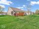 Expansive backyard with a well-maintained lawn, a deck and a charming fence at 6502 E Walton Dr, Camby, IN 46113