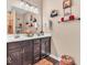 Bathroom featuring a double sink vanity with dark cabinets, great lighting, and wood-look flooring at 6502 E Walton Dr, Camby, IN 46113