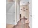 Well lit bathroom featuring wood flooring, decorative fixtures, and beige walls at 6502 E Walton Dr, Camby, IN 46113