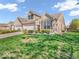 Inviting brick townhome featuring a lush green lawn and beautiful landscaping at 6502 E Walton Dr, Camby, IN 46113