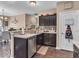 Open-concept kitchen with dark wood cabinetry and stainless steel appliances, perfect for Gathering gatherings at 6502 E Walton Dr, Camby, IN 46113