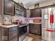 Updated kitchen boasts dark wood cabinets, stainless appliances and tile backsplash at 6502 E Walton Dr, Camby, IN 46113