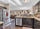 The kitchen offers stainless steel appliances, dark wood cabinetry and hard surface flooring at 6502 E Walton Dr, Camby, IN 46113