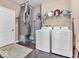 Functional laundry area featuring white appliances, shelving, and a clean, organized space at 6502 E Walton Dr, Camby, IN 46113