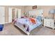 Comfortable bedroom with ensuite bathroom, white headboard, neutral walls, and carpet at 6502 E Walton Dr, Camby, IN 46113