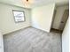A bright bedroom features a large window and neutral carpeting, offering a cozy retreat at 653 Southridge Ct, Westfield, IN 46074