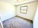 Simple bedroom with neutral carpet, white walls, and natural light from the window at 653 Southridge Ct, Westfield, IN 46074