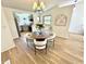 Dining room featuring a round table, hardwood floors, a chandelier, and an adjacent kitchen at 653 Southridge Ct, Westfield, IN 46074