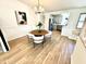 Bright dining room with a chandelier, wood floors, and an adjacent kitchen at 653 Southridge Ct, Westfield, IN 46074